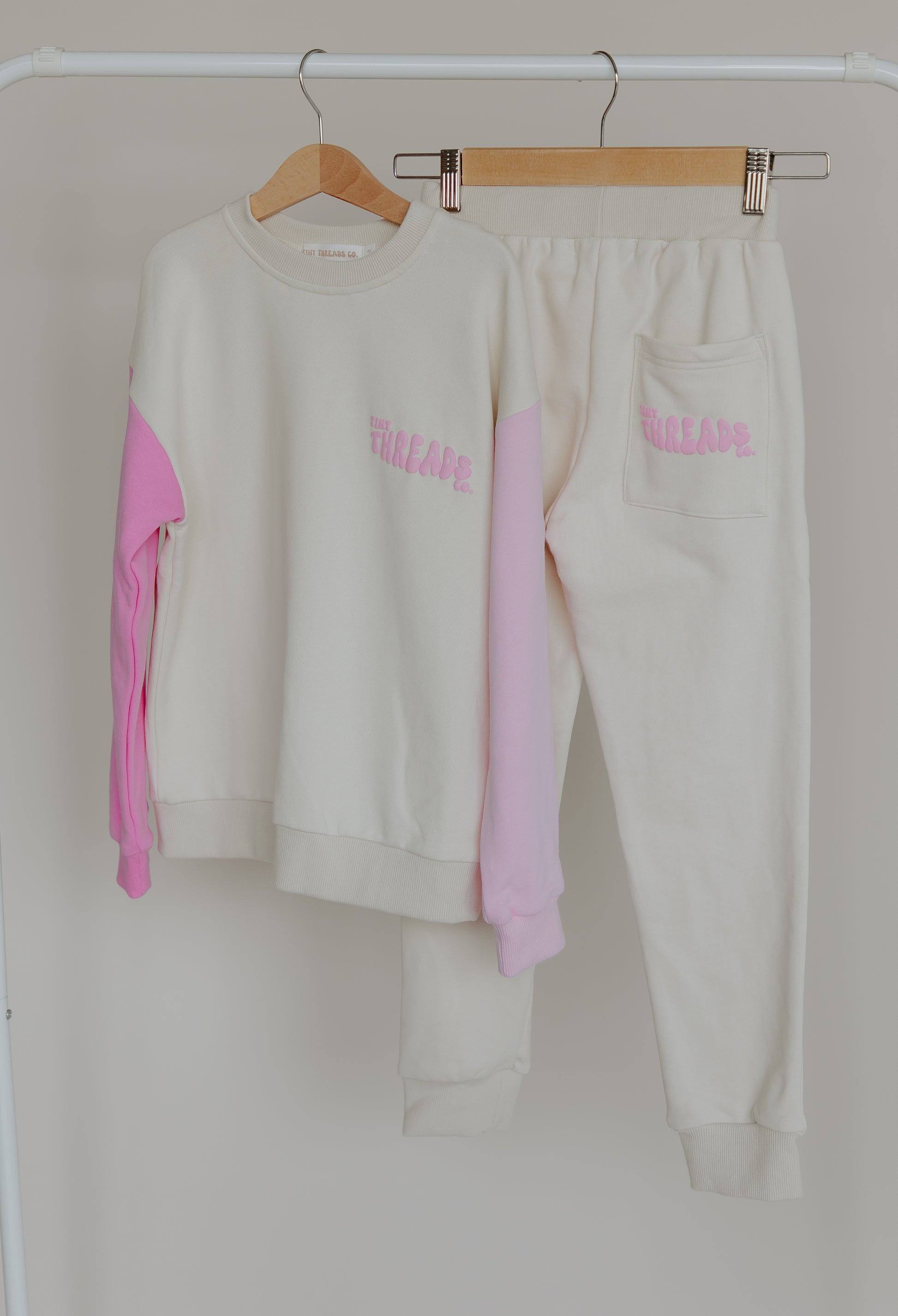 Tiny Threads Co. oversized long sleeve set in pink, front view of jumper, rear view of pants