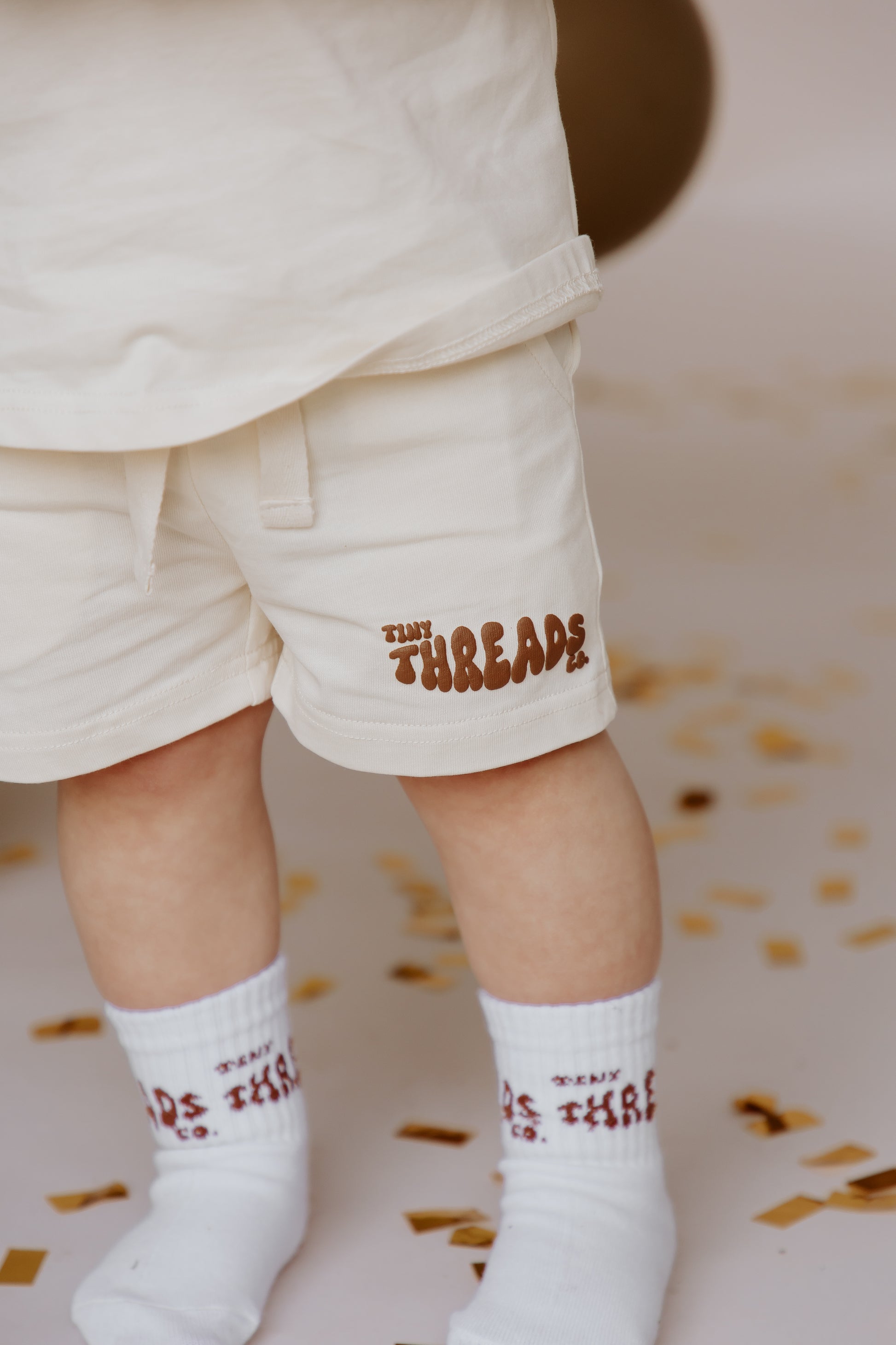 Tiny Threads Co. oversized short sleeve set in brown, worn by H aged 22 months, focusing on shorts