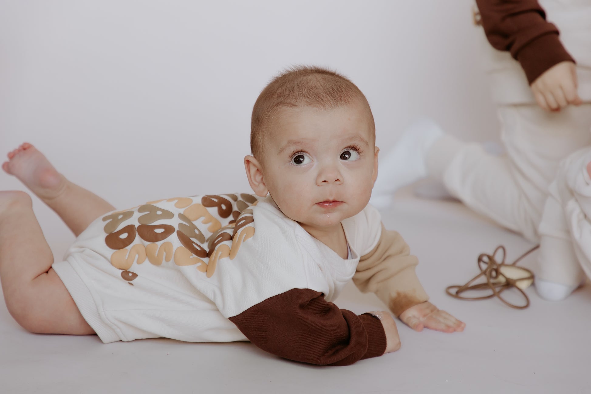 Tiny Threads Co. oversized long sleeve romper in brown worn by B, aged 5.5 months corrected