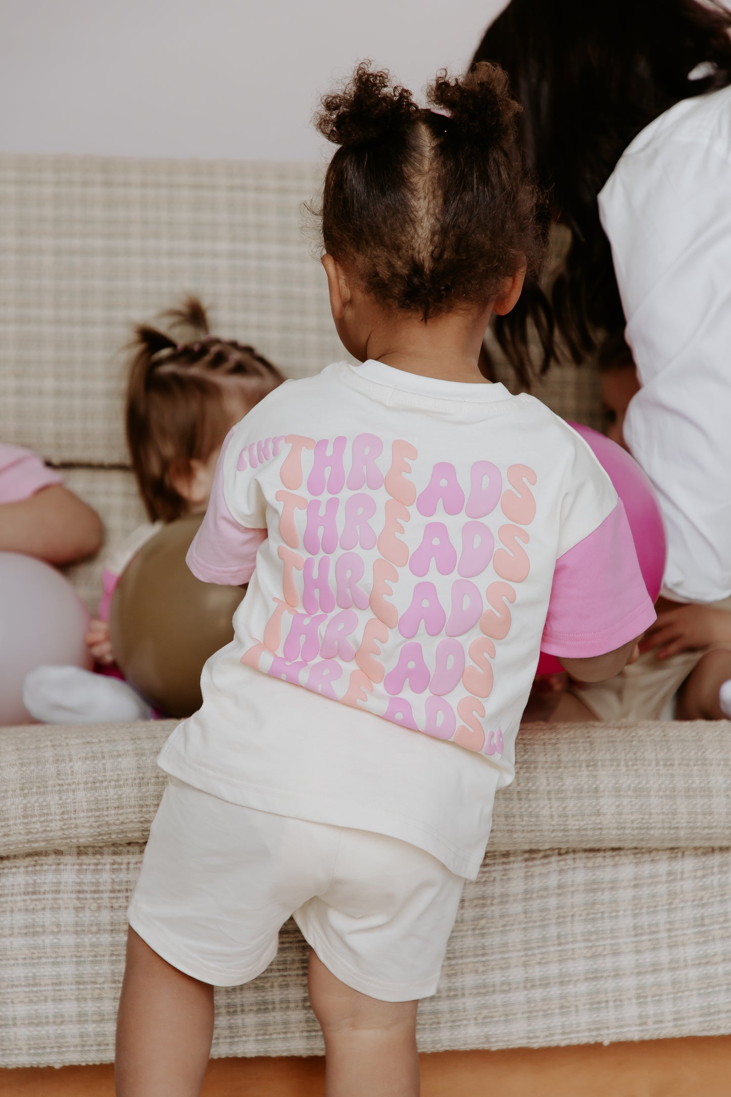 Tiny Threads Co. oversized short sleeve set in pink, worn by D aged 26 months, rear of set in focus